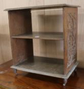 A carved walnut open bookshelf W.55cm