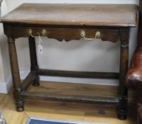 A Cromwellian oak side table, fitted single long drawer with shaped frieze, on gun barrel turned