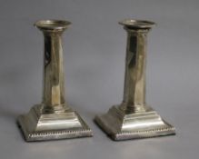 A pair of Edwardian silver candlesticks, with panelled stems, Ellis Jacob Greenberg, Birmingham,