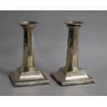 A pair of Edwardian silver candlesticks, with panelled stems, Ellis Jacob Greenberg, Birmingham,