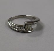 A modern 18ct white gold and fancy set single stone diamond ring with diamond set shoulders, size