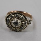 An antique yellow and white metal, diamond set oval dress ring, size O.