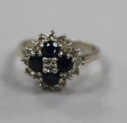 An 18ct white gold, sapphire and diamond cluster dress ring, size N.