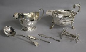 Two silver sauceboats, a pair of Victorian silver knife rests, a George III silver sauce ladle and