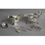 Two silver sauceboats, a pair of Victorian silver knife rests, a George III silver sauce ladle and