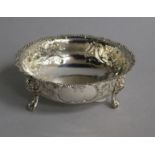 A Victorian embossed silver sugar bowl, on claw and ball feet, Robert Harper, London, 1874, 12.1cm.