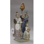 A Lladro group of Valencian figures with oranges and roses