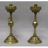 A pair of brass enamelled Victorian gothic candlesticks height 30cm