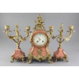 An early 20th century French pink marble clock garniture, with applied shell, scroll and dolphin