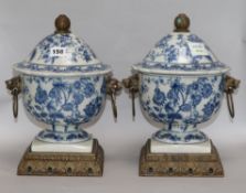 A pair of green toleware candlestands and a pair of Chinese blue and white lidded vases vases height