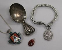 An Arts & Crafts white metal caddy spoon, a silver commemorative bracelet, a silver and enamel