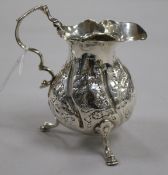 A Georgian silver cream jug with later embossed decoration, London, 1757?, 10cm.