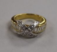 A modern 18ct gold, baguette and princess cut diamond dress ring with central 'X' motif, size M.