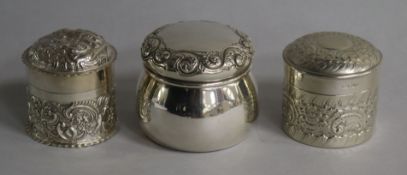Two late Victorian repousse silver boxes and covers including William Comyns and one other