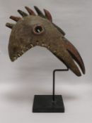 An African art bird mask on stand overall height 48cm