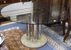 A circular glass top table with chrome base W.130cm