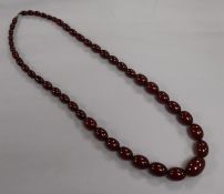 A single strand simulated cherry amber necklace, gross weight 96 grams, 78cm.