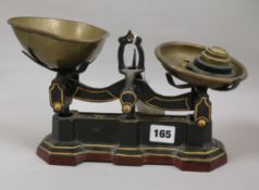 A set of Victorian black painted scales and brass pans