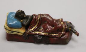 A cold painted bronze figure of a reclining figure