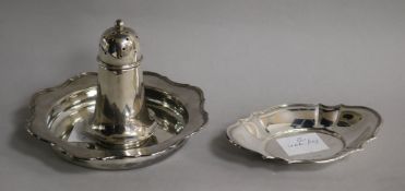 A George V silver circular dish a silver oval dish and a silver sugar sifter.