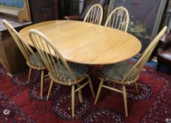 A light oak Ercol table and five chairs W.170cm fully extended