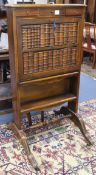 A mahogany writing desk, the fall with faux book front W.69cm