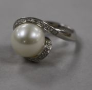 An 18ct white gold, diamond and cultured pearl dress ring, size M.