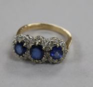 A modern 9ct gold sapphire and diamond triple cluster ring, size N.