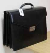 A black leather attaché case by Salvatore Ferragamo, with combination lock