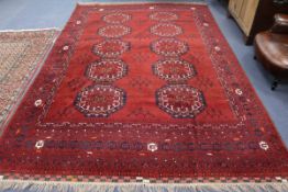A deep red Bokhara rug 345 x 230cm