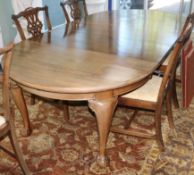 A Chippendale style circular mahogany extending dining table (three additional leaves) W.240cm
