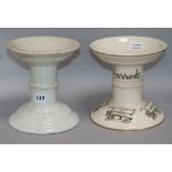 Two white glazed ceramic ham bone stands, one printed "Harrods"