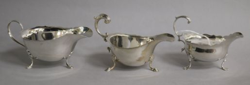 A small George III silver sauceboat (a.f.), London, 1767 and two 20th century silver sauceboats.