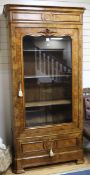 A mid 19th century French burr walnut bookcase, enclosed by a glazed door W.107cm H.215cm