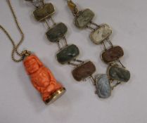 A yellow metal mounted cameo lava bracelet and a carved coral pendant on a chain.