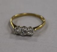 An 18ct gold, platinum and three stone diamond ring, size M/N.