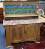 A late 19th century mahogany Aesthetic movement mahogany marble topped washstand with tiled back,