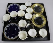 A set of five Royal Worcester coffee cans and saucers with silver can holders and one other