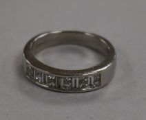 A modern platinum, baguette and princess cut diamond half hoop ring, size H.