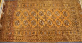 An orange ground Persian rug 200 x 110cm