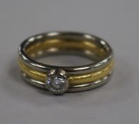 A modern two colour 18ct gold and collet set solitaire diamond ring, size N.