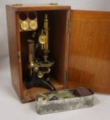 A cased Baker microscope and slides case height 39cm