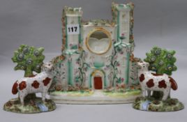 A pair of staffordshire cows and a castle flatback tallest 23cm