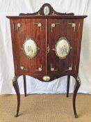 A 1940's mahogany cabinet with porcelain panels and brass filigree W.68cm