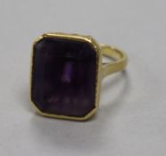 An 18ct gold and amethyst set dress ring, size M.