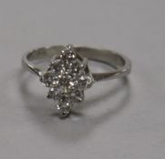 A platinum and lozenge shaped diamond cluster ring, size L/M.