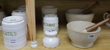 A collection of white glazed terracotta storage jars, two marble pestles and mortars, etc.