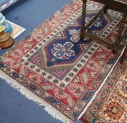 A red blue and cream ground rug 198 x 118cm
