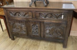 A reproduction carved oak sideboard W.146cm
