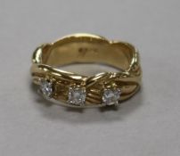 A 14ct gold and claw set three stone diamond dress ring, size O.